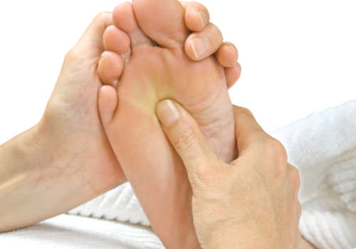 Foot reflexology, a thumb is applying pressure to the sole of a foot